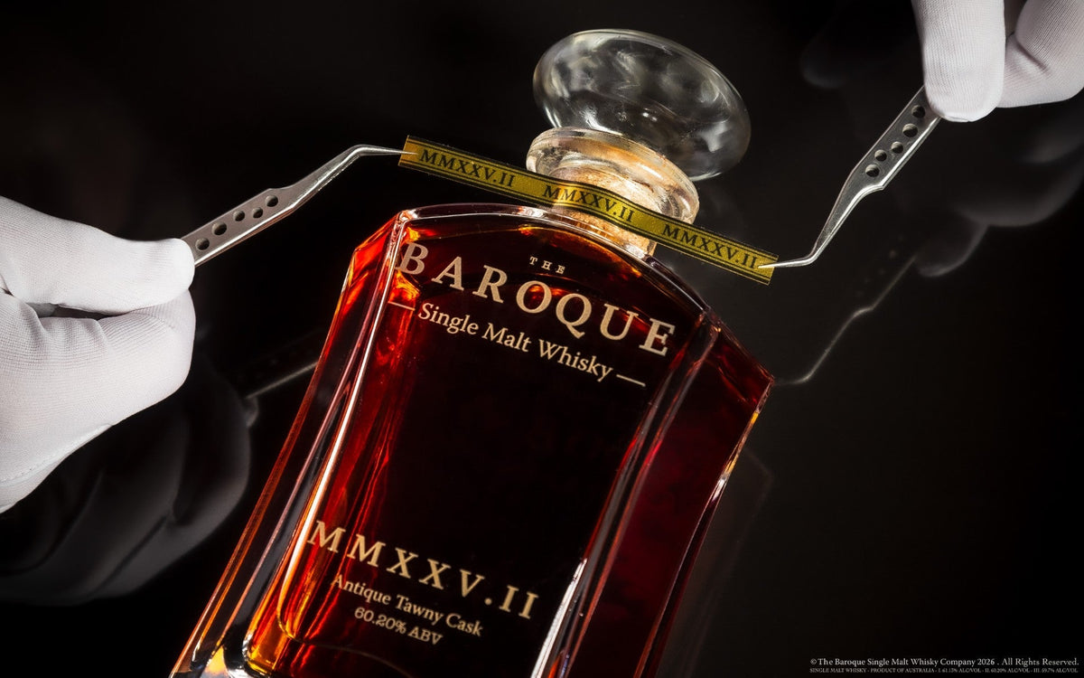Gloved hands fitting the numbered band to a Baroque MMXXV Edition II decanter with tweezers