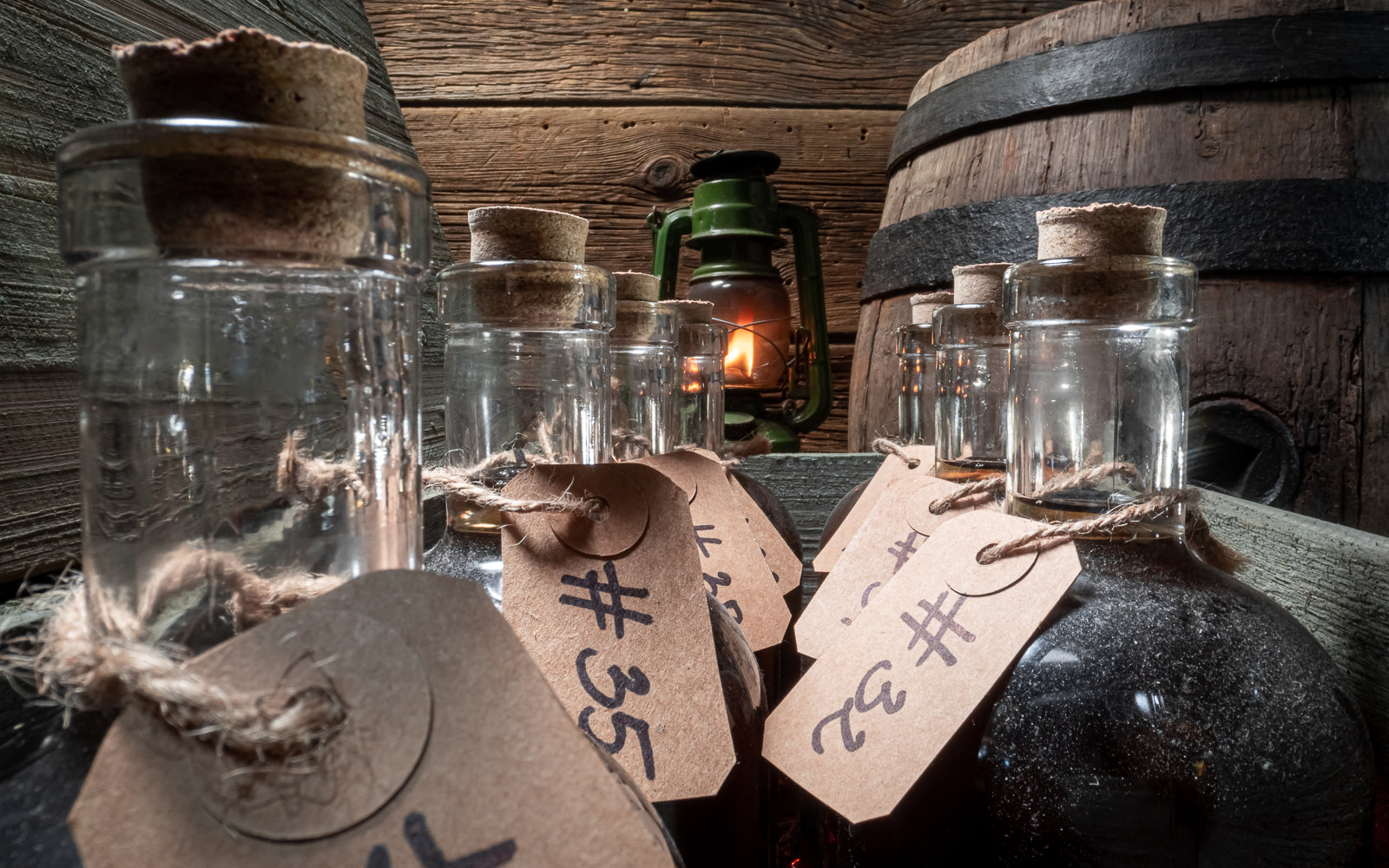 Vintage apothecary bottles aged on weathered wood, an emblem of collector legitimacy earned over time. Baroque Whisky Australian Single Malt.