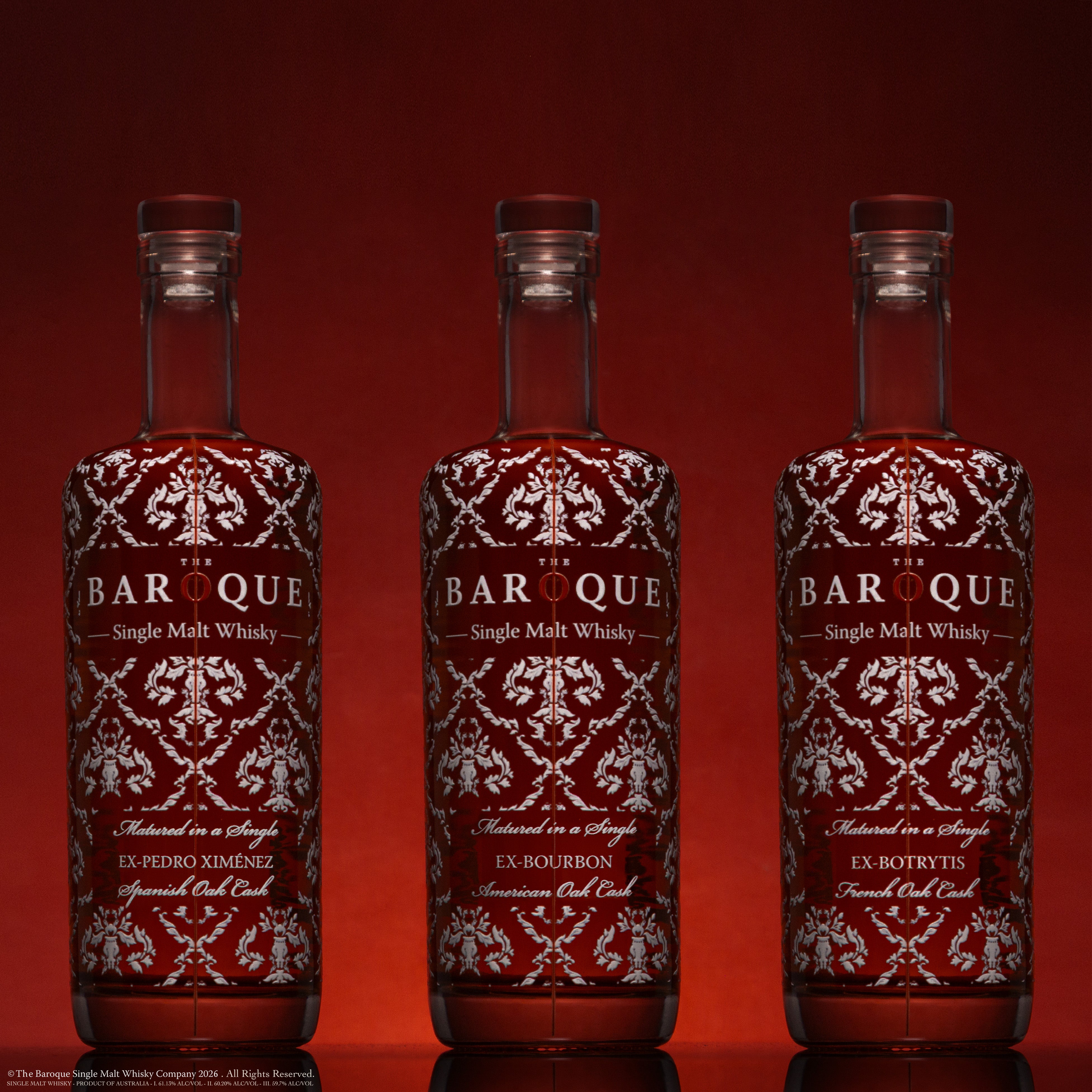 The three Baroque Premium Range single cask bottles on deep red, left composition