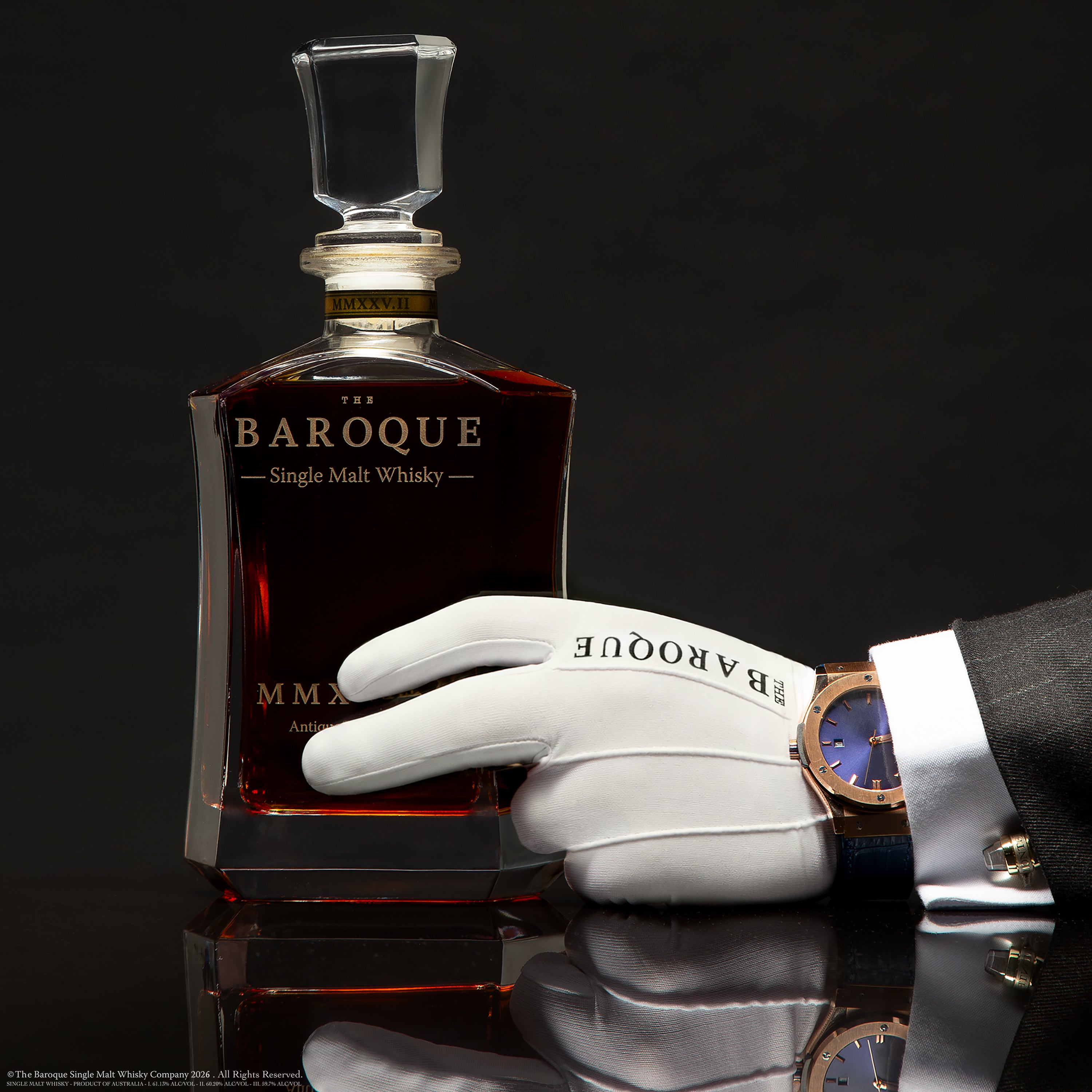 White gloved hand with fine watch resting on the Baroque MMXXV Edition II decanter, Antique Tawny Cask