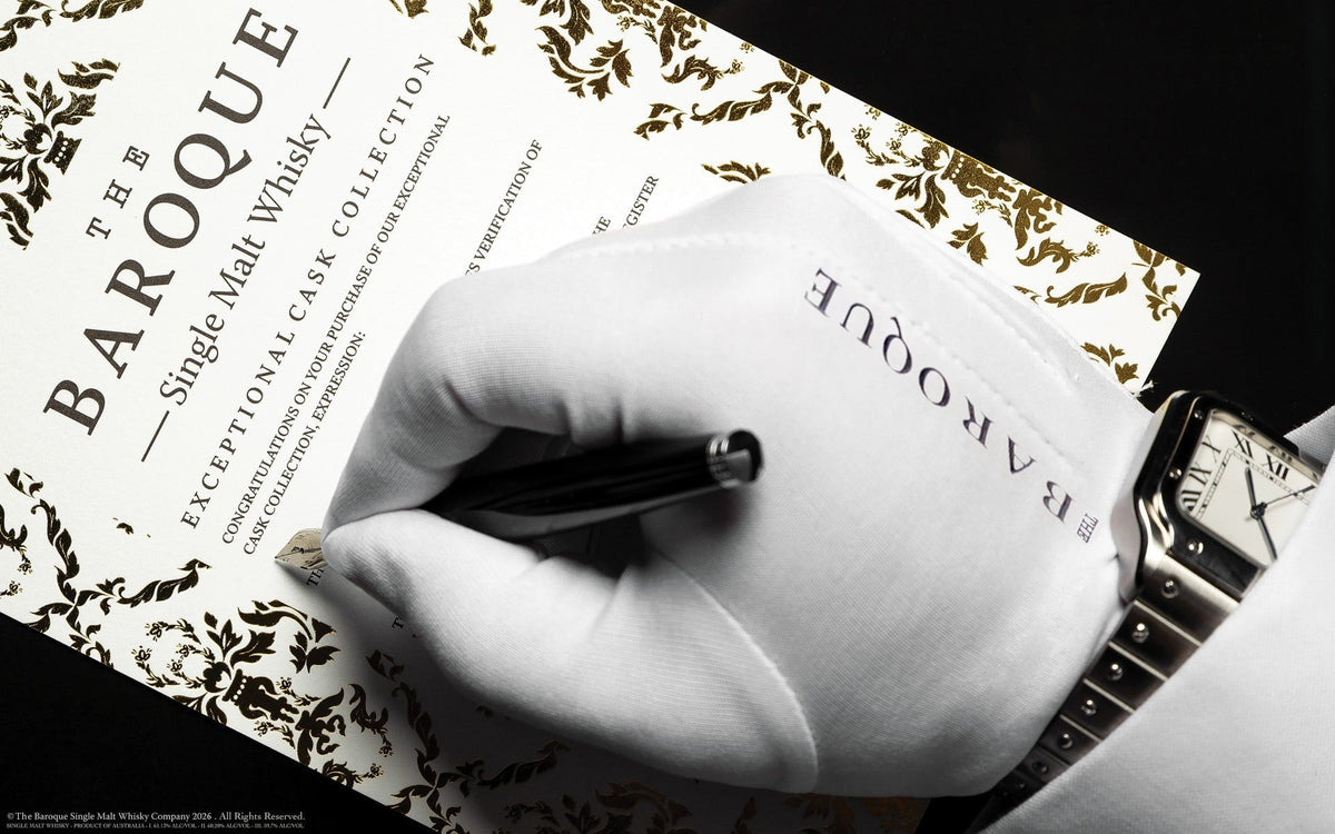 Gloved hand and fine watch signing a Baroque Exceptional Cask Collection certificate