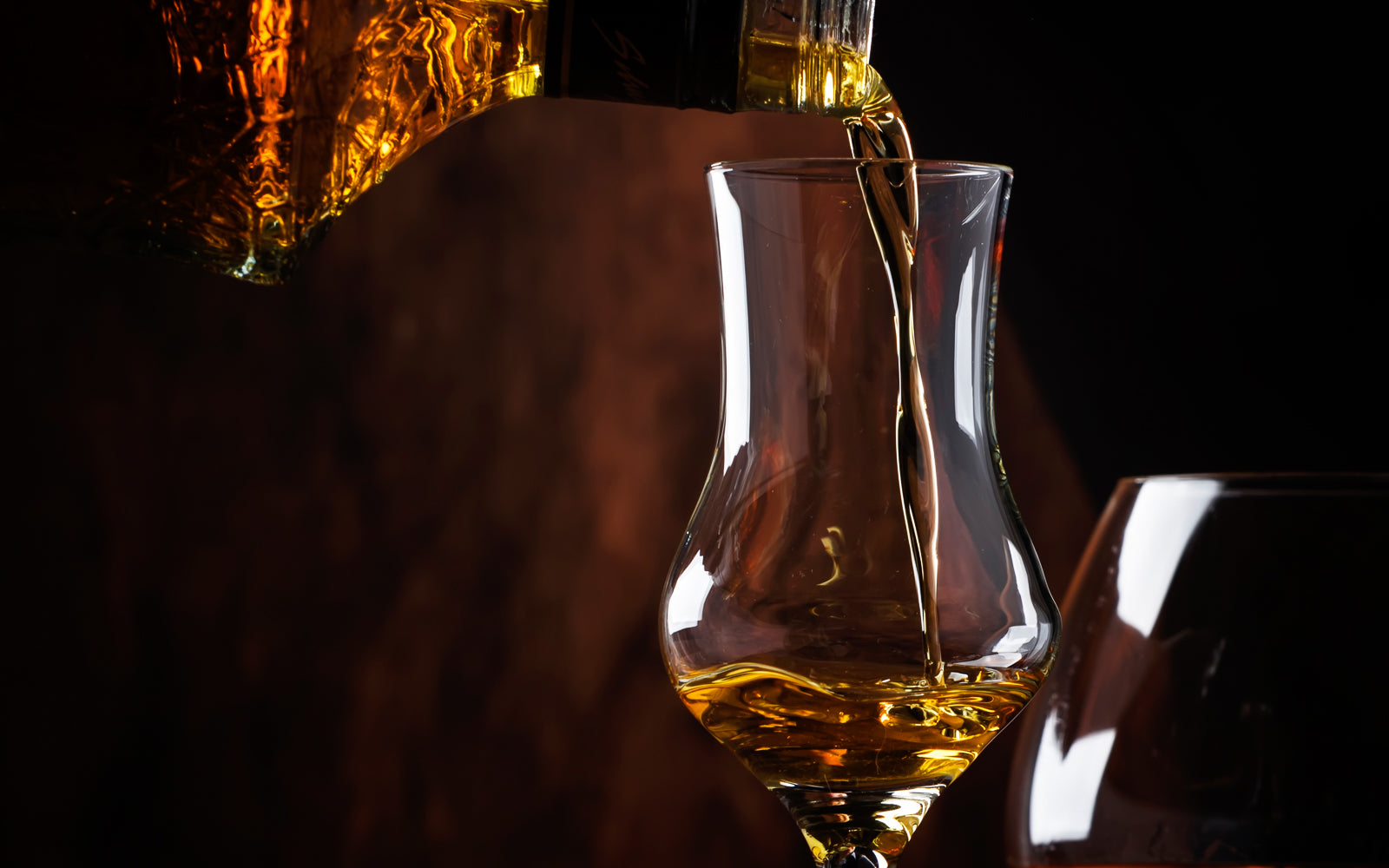 Whisky poured from bottle into a glass, the reward of a considered private cellar. Baroque Whisky Australian Single Malt.