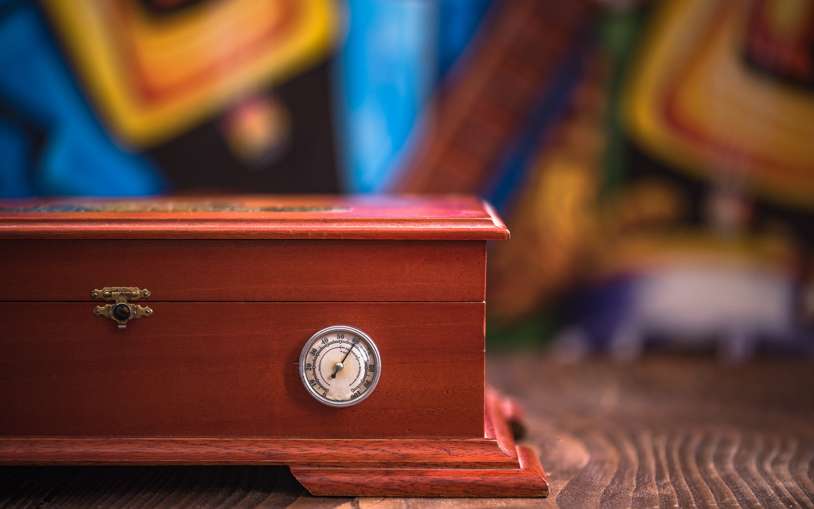 A wooden cigar humidor with hygrometer, evoking the art of pairing aged cigars with Single Malt. Baroque Whisky Australian Single Malt.