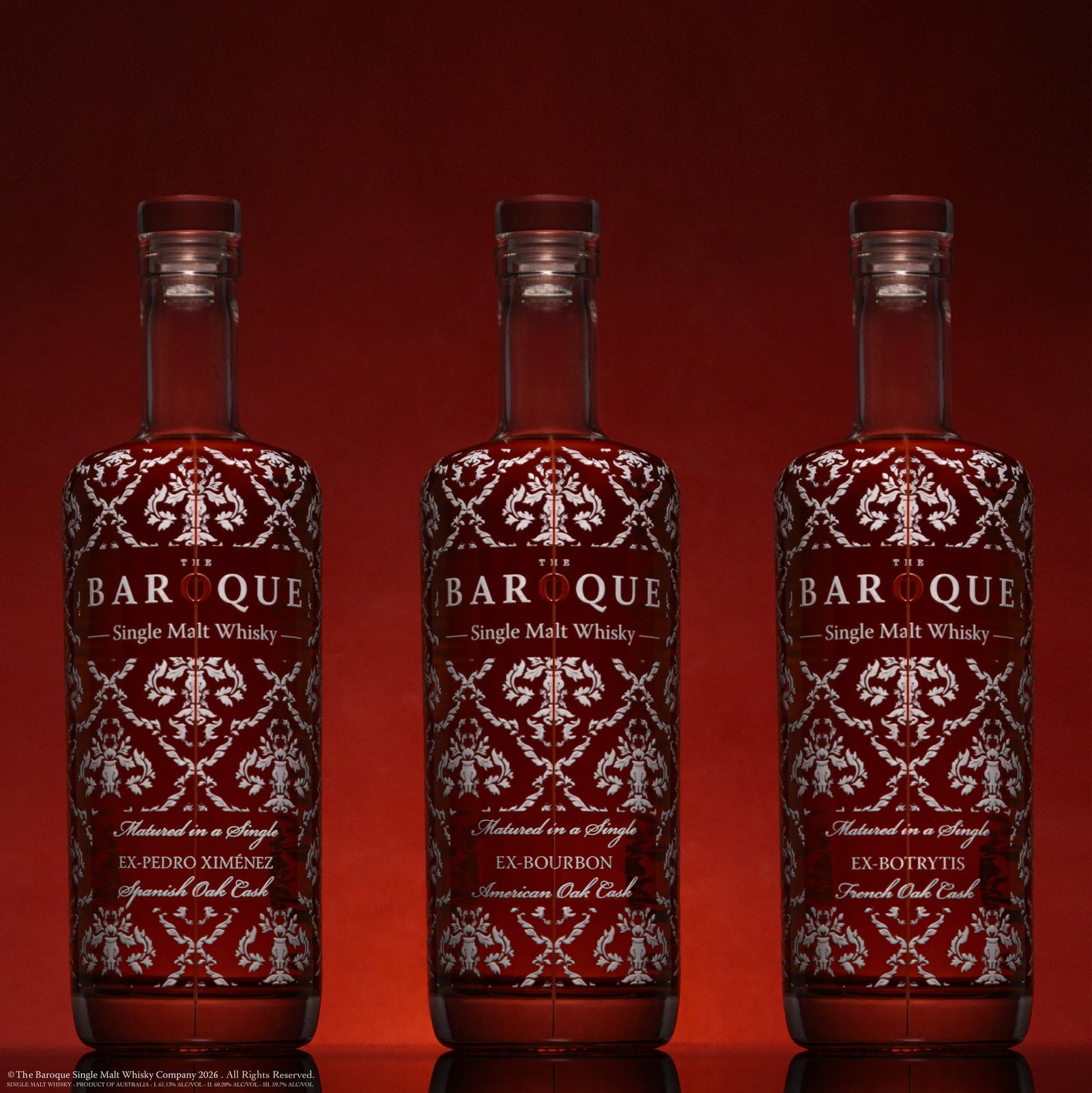 The three Baroque Premium Range single cask bottles on deep red, left composition
