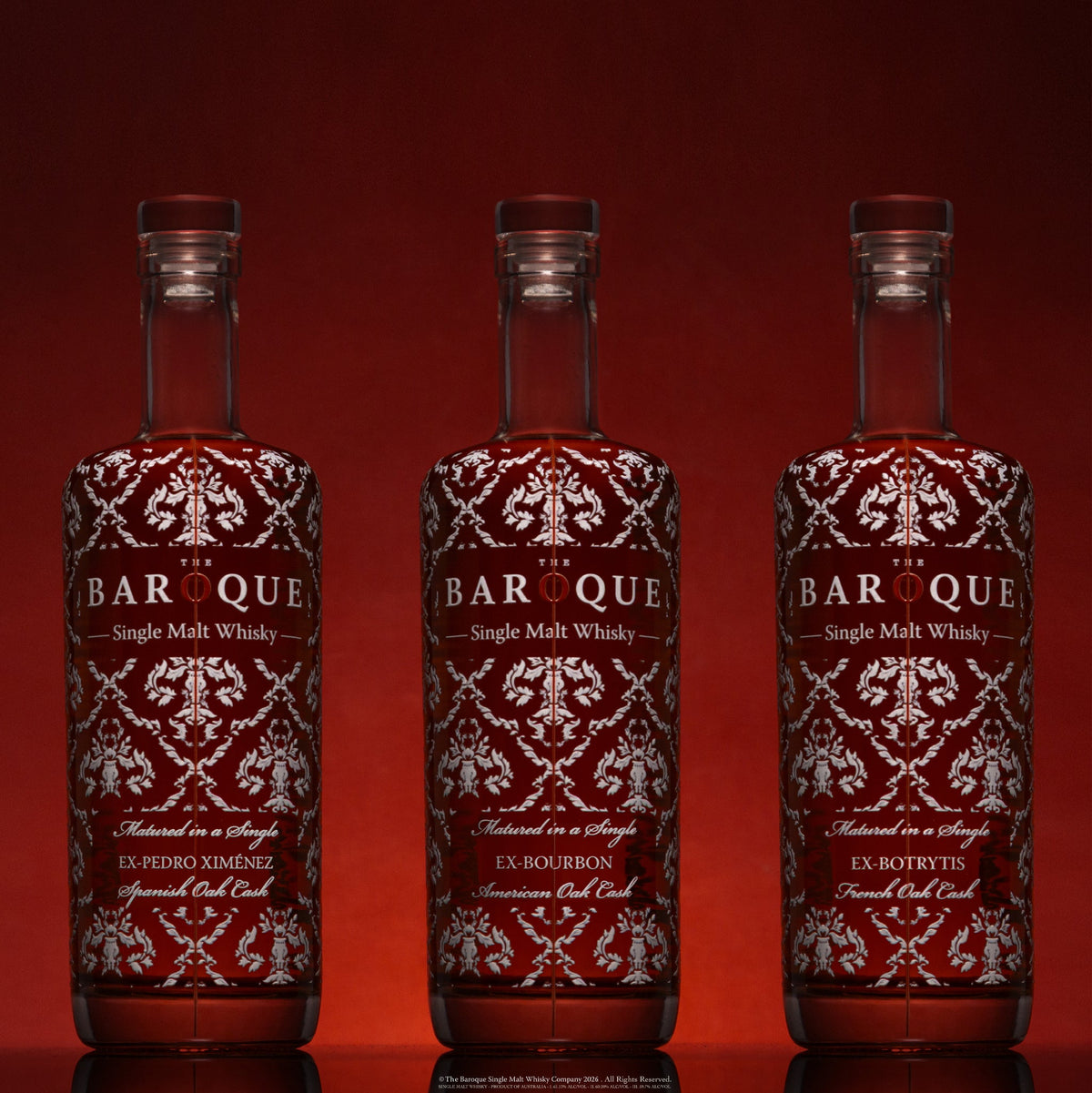 The three Baroque Premium Range Single Malt bottles together on deep red: ex-Pedro Ximénez, ex-Bourbon and ex-Botrytis