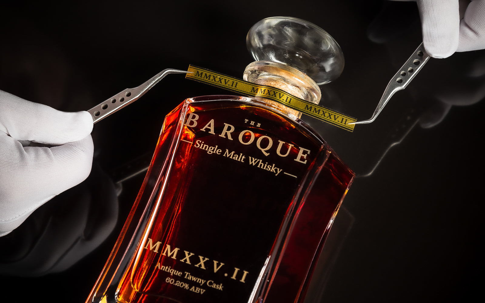 Numbered edition band MMXXV.II placed by tweezers on a Baroque Whisky decanter, individually numbered single cask Australian Single Malt provenance