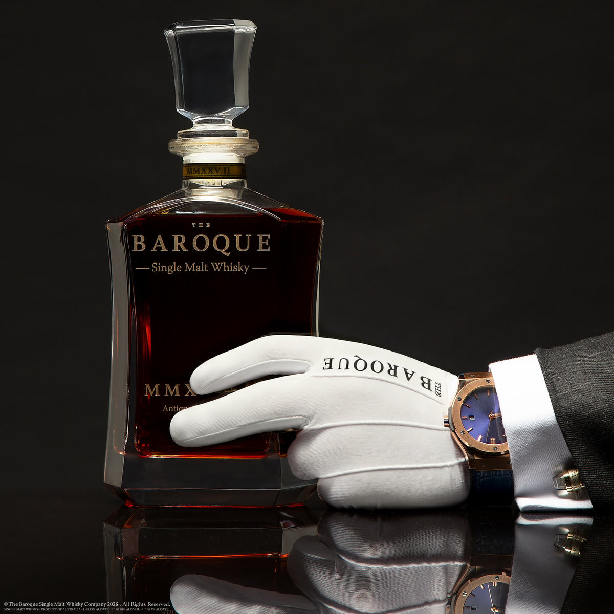 White gloved hand with fine watch resting on the Baroque MMXXV Edition II decanter, Antique Tawny Cask