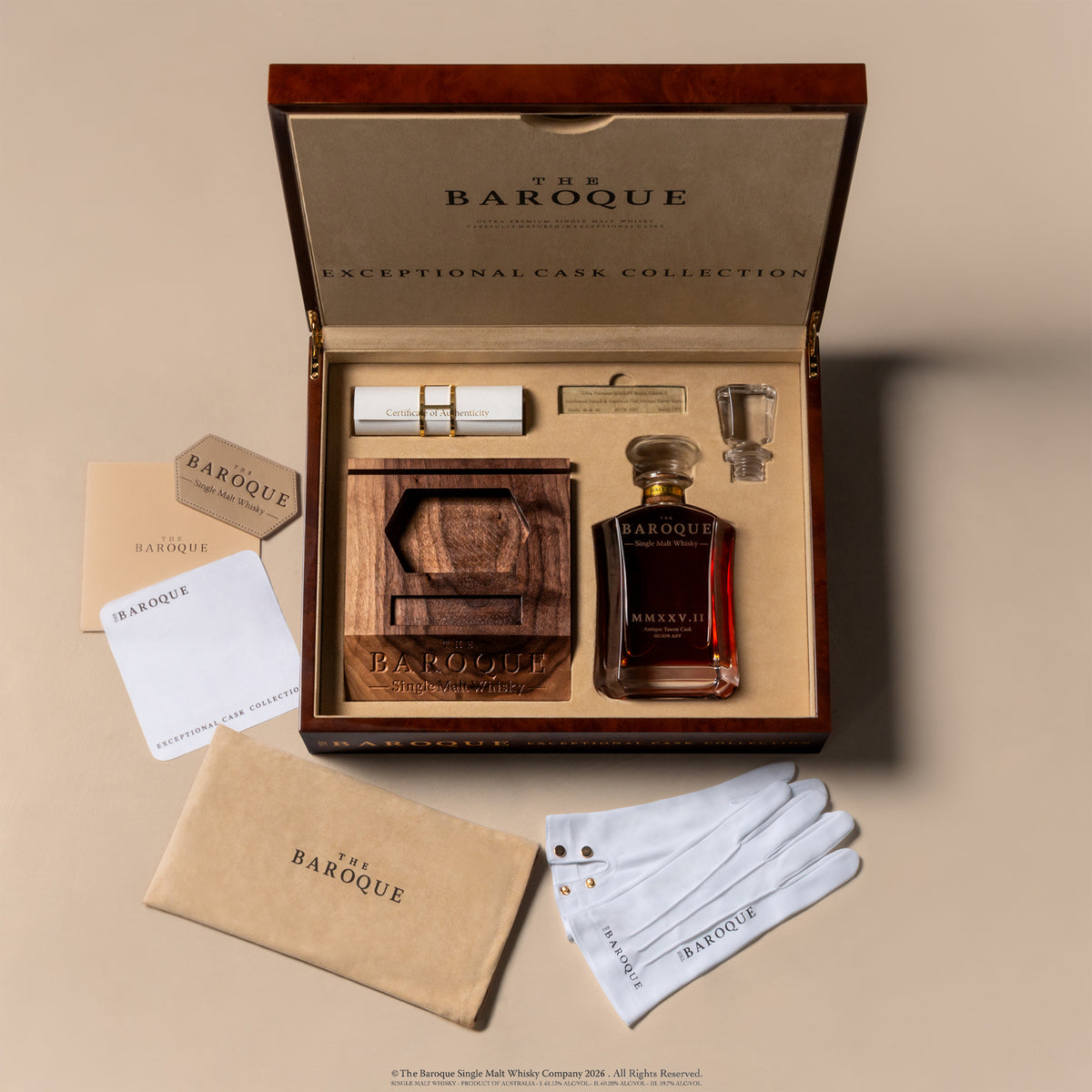 Overhead view of the open Baroque MMXXV Edition II case with decanter, certificate, numbered plaque, tasting glass, gloves and suede pouch